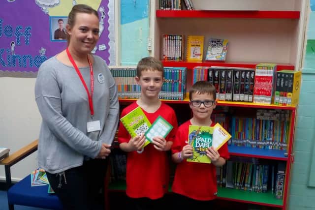 Asquith pupils with some of the books from their new library