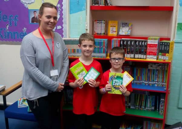 Asquith pupils with some of the books from their new library