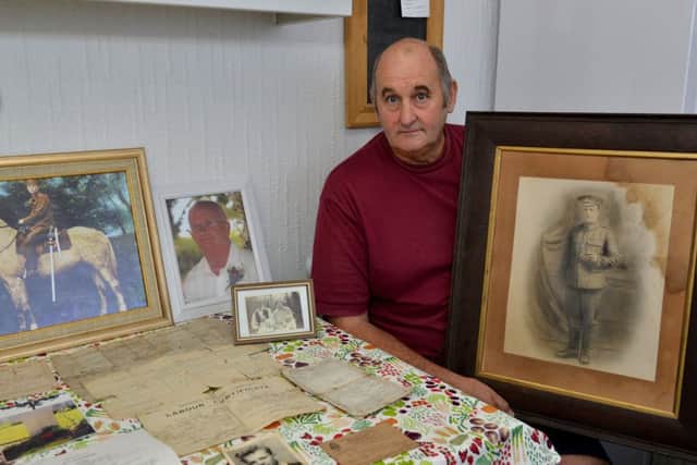 Kevin Mayes is pictured with a picture of his Great Grandfather