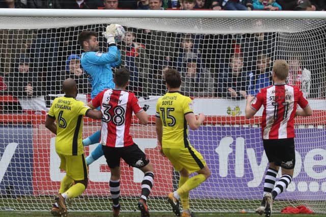 Exeter City FC v Cheltenham Town FC  at St James Park (Sky Bet League Two - 2 April 2018) - Scott Flinders makes a save

Picture by Antony Thompson - Thousand Word Media, NO SALES, NO SYNDICATION. Contact for more information mob: 07775556610 web: www.thousandwordmedia.com email: antony@thousandwordmedia.com

The photographic copyright (Â© 2017) is exclusively retained by the works creator at all times and sales, syndication or offering the work for future publication to a third party without the photographer's knowledge or agreement is in breach of the Copyright Designs and Patents Act 1988, (Part 1, Section 4, 2b). Please contact the photographer should you have any questions with regard to the use of the attached work and any rights involved.