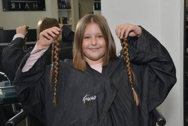 Brave eight year old Emily from Mansfield has 11 inches of hair cut for charity