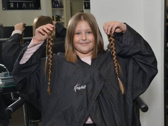 Brave eight year old Emily from Mansfield has 11 inches of hair cut for charity