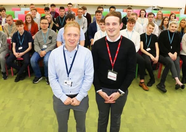 Tutor Alex Norbury with Asda manager Dan Wharrier and business students.