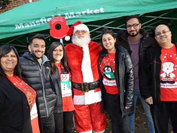 Alka Bhatt, left, and her husband Kalpesh, right, who run the Post Office on Ladybrook Square, are joined by their family at the launch of their first Christmas festivity of the season which saw an early appearance of Santa to welcome visitors to their arts and crafts fayre.  Also pictured are Jeevan Fermahan, Hanisha Bhatt, Manisha Bhatt and Bhavesh Parmar.