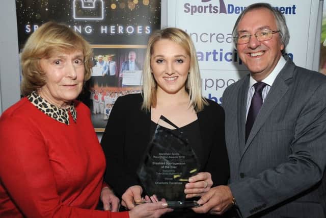 Swimmer-turned-canoeist Charlotte Henshaw (centre) picks up one of her awards.