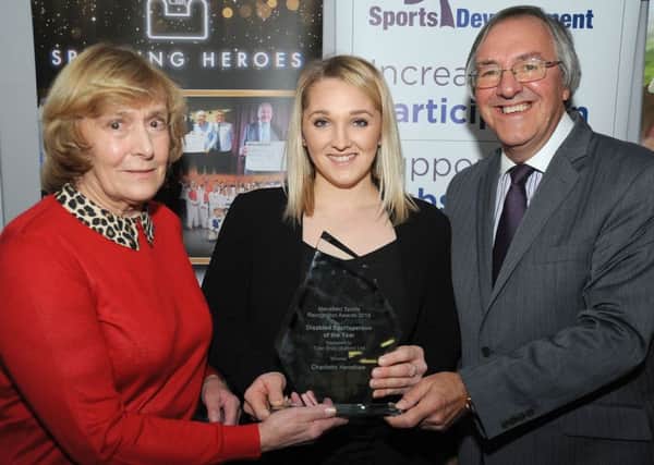 Swimmer-turned-canoeist Charlotte Henshaw (centre) picks up one of her awards.