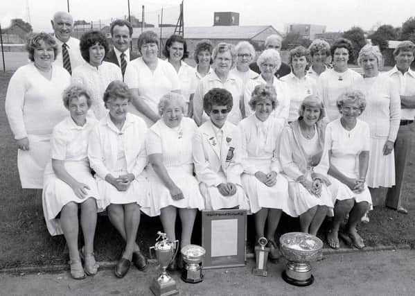 1982: Mansfield ladies bowling club finals. This glamourous bunch of ladies.....- oops and gentlemen - look like they won, judging by all the trophies laid before them.