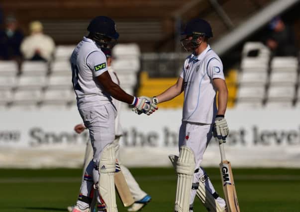 Chesney Hughes and Ben Slater celebrate their 50 run opening partnership during Derbyshire County Cricket Club second innings at 3aaa County ground, Derby on 11 May 2015.  Photo: Simon Trafford