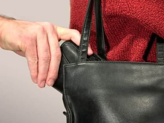 Purse bells handed out to tackle 'handbag dipping' crime