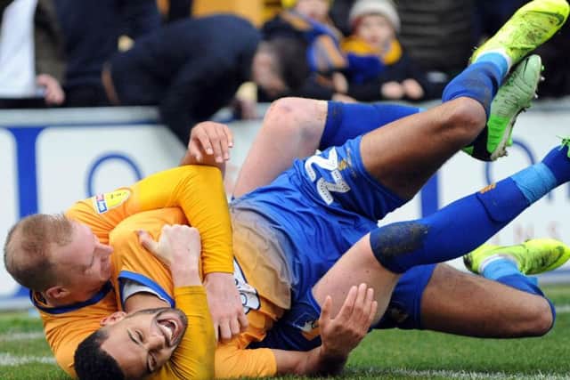 CJ Hamilton is embraced by Neal Bishop after scoring the second Stags goal. Photo: Anne Shelley.