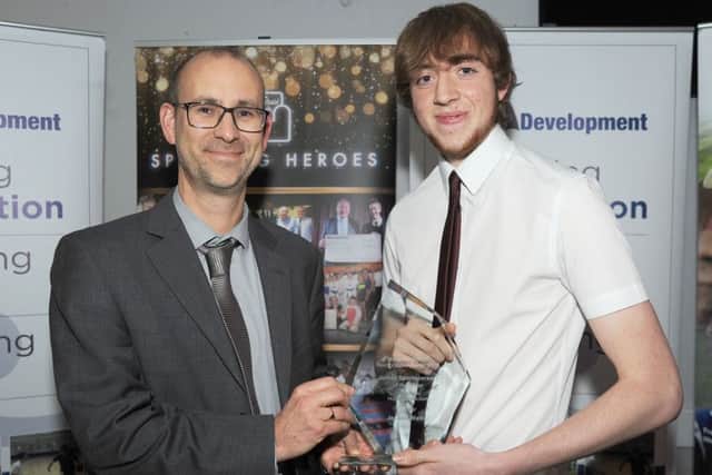 Taekwondo champion Joshua Walker receives his junior sportsperson of the year award.