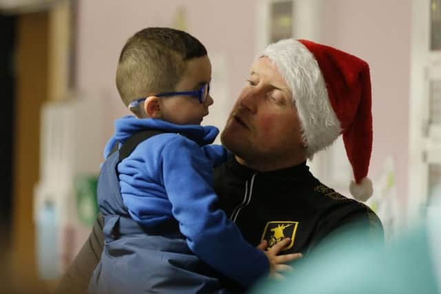 Goalkeeper Conrad Logan with a young boy. Photograph courtesy of Mansfield Town Football Club.