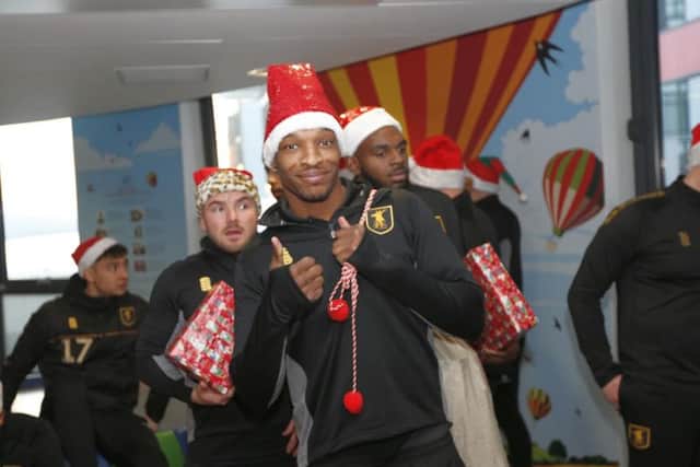 Defender Krystian Pearce bearing gifts at the ward. Photograph courtesy of Mansfield Town Football Club.