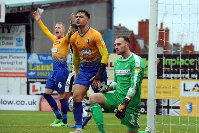 Mansfield Town v Notts County
Neal Bishop and Tyler Walker appeal after a corner decision goes against them.