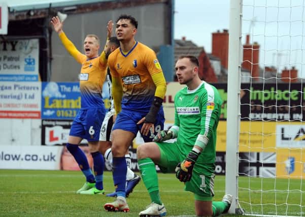 Mansfield Town v Notts County
Neal Bishop and Tyler Walker appeal after a corner decision goes against them.