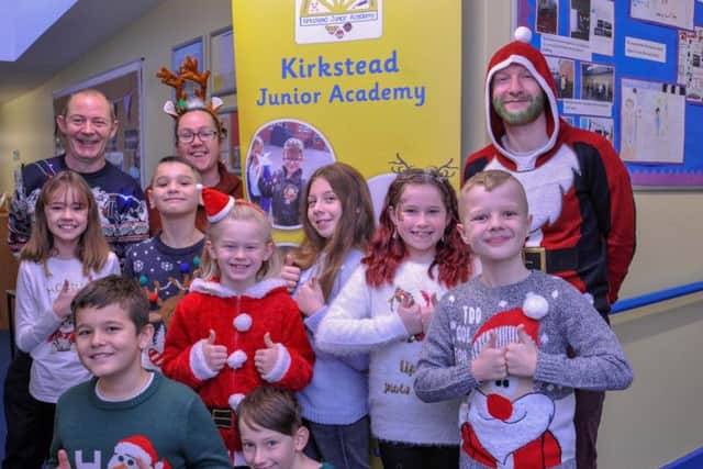 Kirkstead Junior Academy staff and children in their fundraising
Christmas Jumpers.