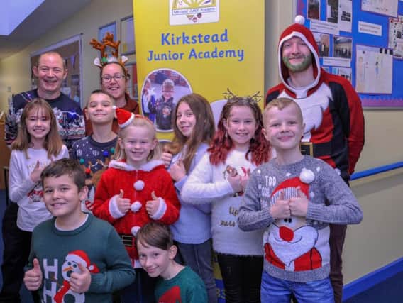 Kirkstead Junior Academy staff and children in their fundraising
Christmas Jumpers.