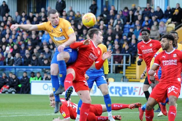Mansfield Town v Swindon.Matt Preston is first to a corner ball.