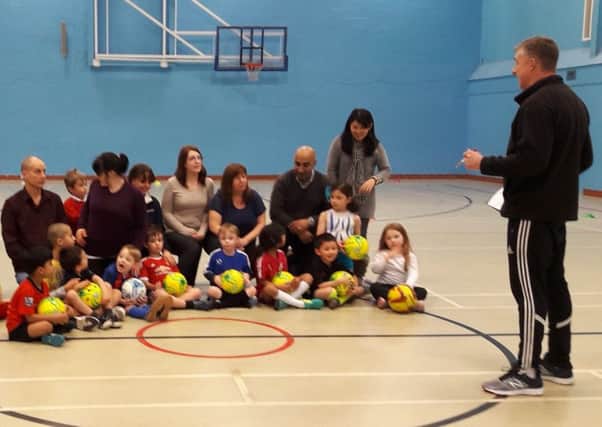 A family football session, run by the Community Sports Project.