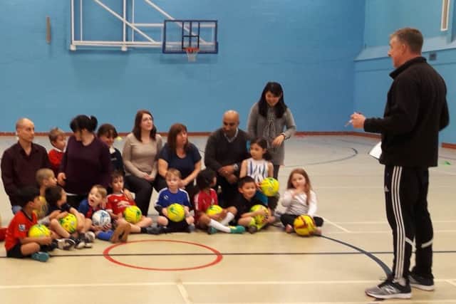 A family football session, run by the Community Sports Project.