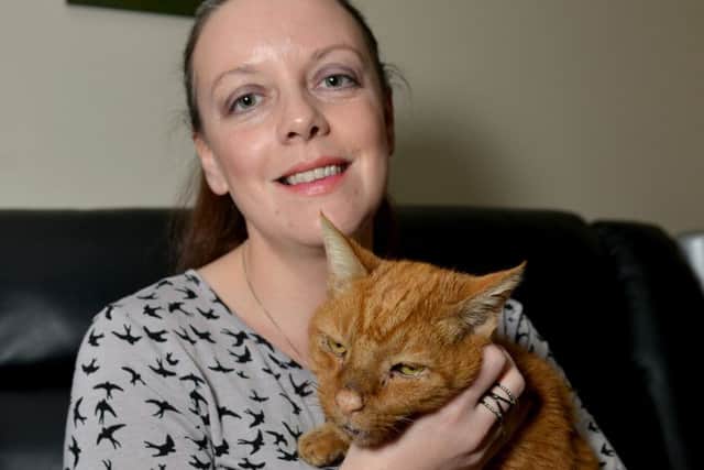 Cecilia Bennett with Alfie, an abandoned cat she is caring for