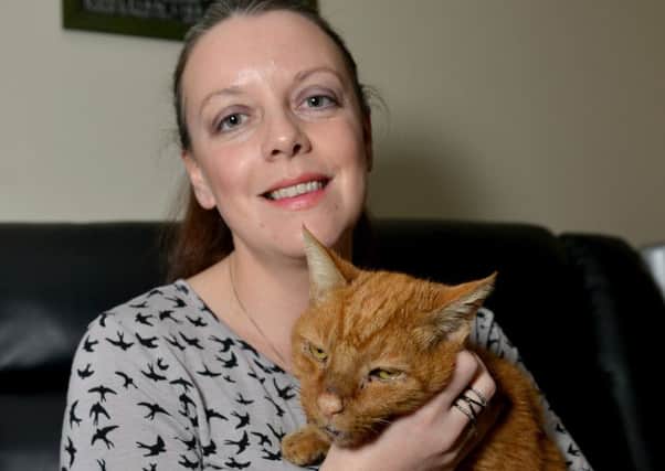 Cecilia Bennett with Alfie, an abandoned cat she is caring for