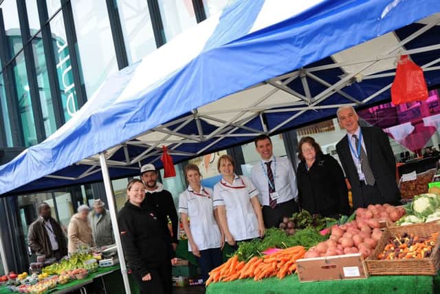 Roxanne Burrows and Laiten McGuigan on their Roots Fruits and Shoots veg stall outside the main entrance at Kings Mill Hospital pictured with from third left, Health and Wellbeing nurses, Charlotte Ranchordas and Amy Gouldstone, from the Estates department, Ben Widdowson and Julie Dennis and the Director of Strategy, Peter Wozencroft.