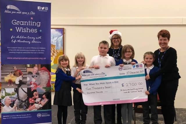 Students and staff with the cheque.