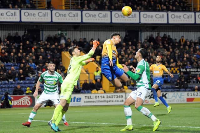 Mansfield Town v Yeovil TownTyler Walker is first to the ball.