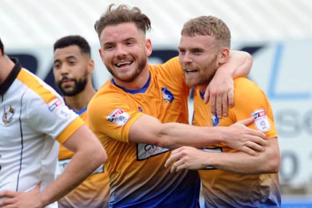 Alex MacDonald (centre) celebrates a Stags goal.