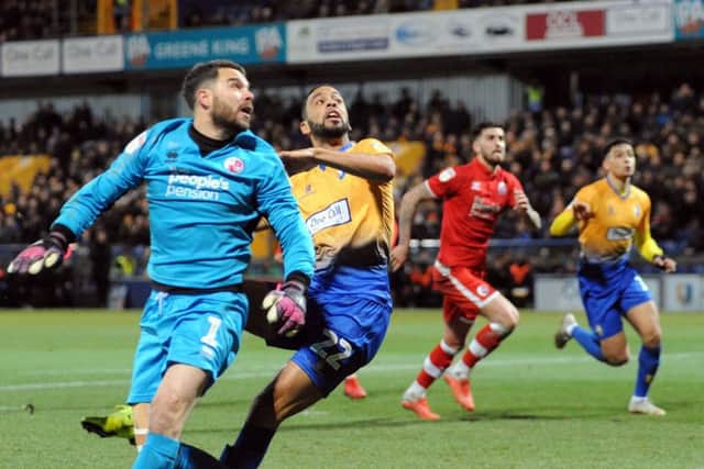 CJ Hamilton chips the keeper to see his attempt land on top of the Crawley net.