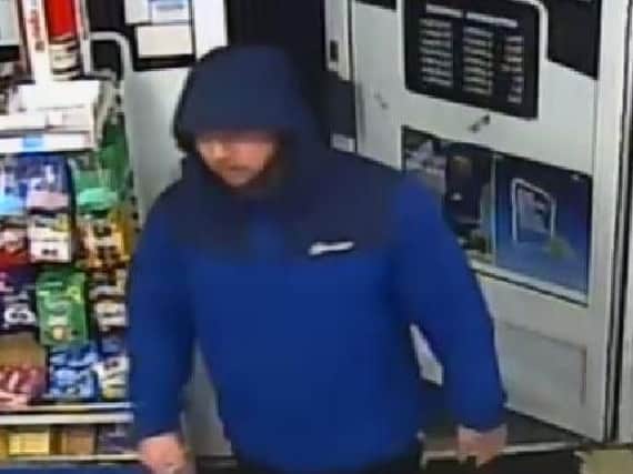 Police would like to speak to the man pictured in connection with a burglary in Sutton