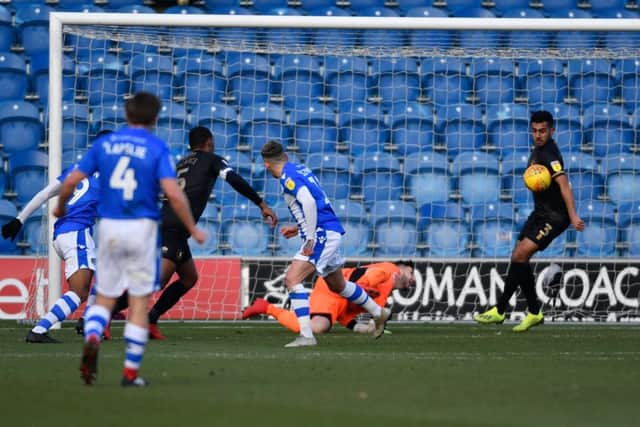 Mansfield Town's Malvind Benning blocks Colchester United's Sammie Szmodic's goal bound shot.