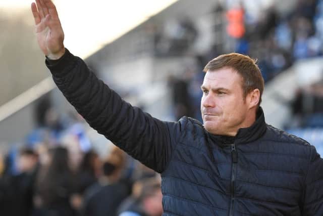 Mansfield Town manager David Flitcroft salutes the travelling Stags fans.