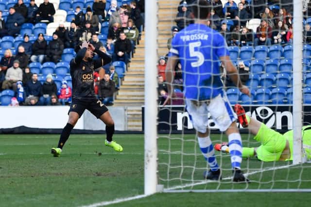 Mansfield Town's Nicky Ajose holds his head as he  puts a header just wide.