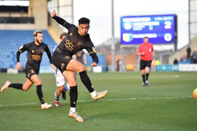 Mansfield Town's Jacob Mellis drives a shot at the Colchester United goal.