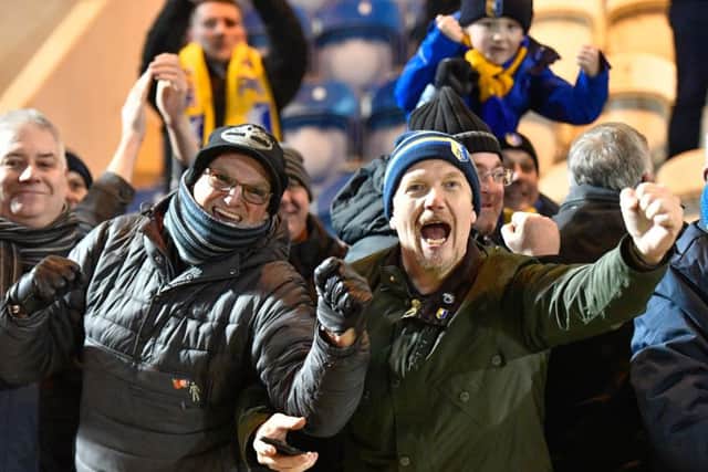 Stags fans celebrate Mansfield Town's remarkable fightback to win 3-2 after trailing 2-0 at half-time.