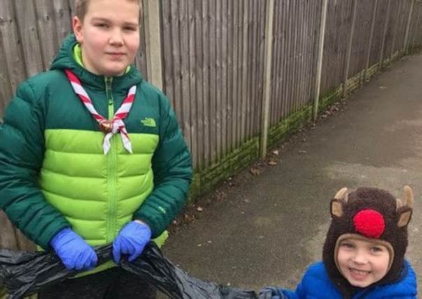 Oliver Harvie 11 and brother Elliott, 5, litter picking in Mansfield Woodhouse.
