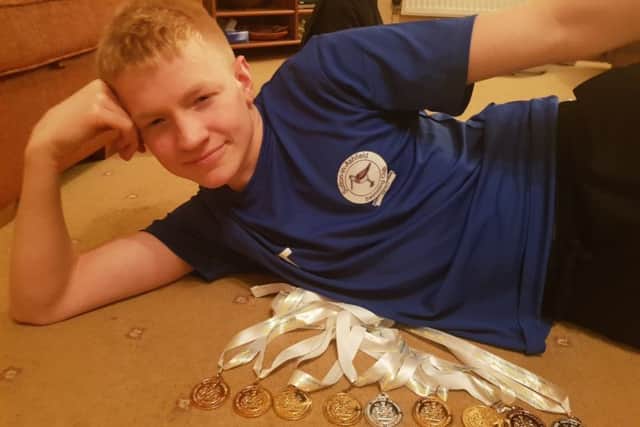 Sutton swimmer Tom Trueman with his haul of nine medals from the county championships.