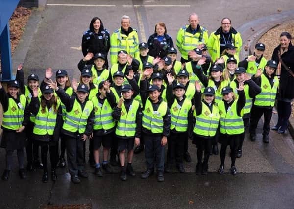 Nottinghamshire Mini Police members, including youngsters from Mansfield's High Oakham Primary School, celebrate the youth scheme's first anniversary.