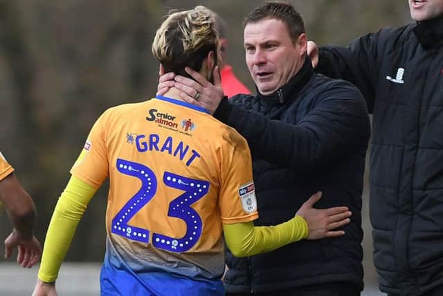 Mansfield's Jorge Grant celebrates his opening goal with manager David Flitcroft.
