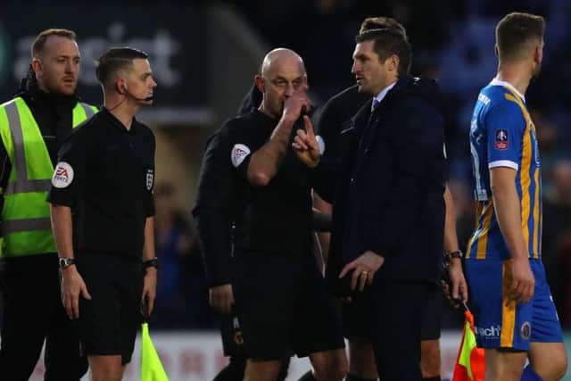 Sam Ricketts speaks with referee Roger East after the FA Cup Fourth Round match between Shrewsbury Town and Wolverhampton Wanderers. (Photo by Catherine Ivill/Getty Images)