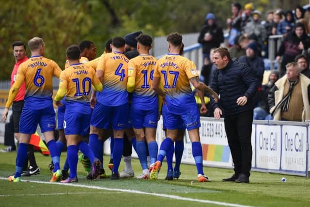 Stags boss David Flitcroft and his players celebrate a goal at the One Call Stadium