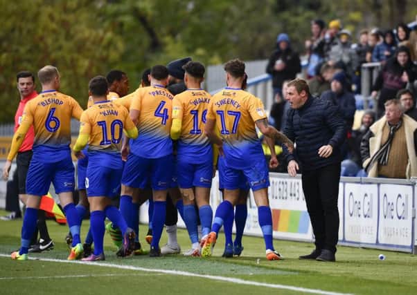 Stags boss David Flitcroft and his players celebrate a goal at the One Call Stadium