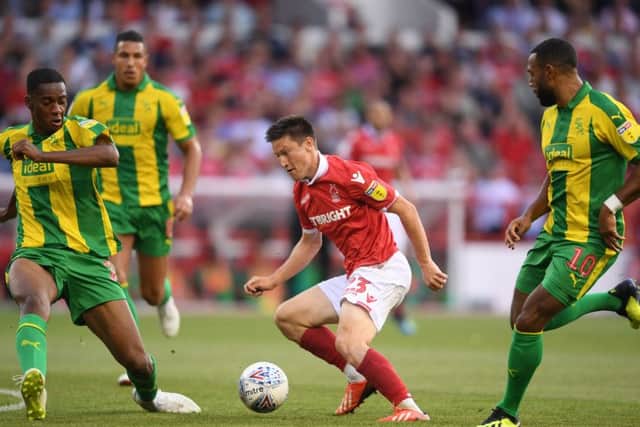 Joe Lolley draws the attention of three West Bromwich Albion defenders