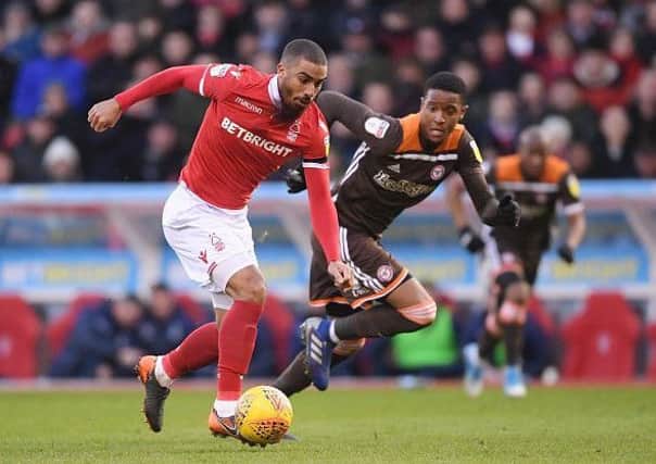 NOTTINGHAM, ENGLAND - FEBRUARY 09: Lewis Grabban of Nottingham Forest skips past the challenge of Ezri Konsa of Brentford during the Sky Bet Championship match between Nottingham Forest and  Brentford at City Ground on February 09, 2019 in Nottingham, England. (Photo by Laurence Griffiths/Getty Images)