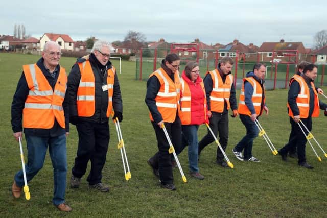 People formed a picket line to sweep Stuart street recreation ground for litter.