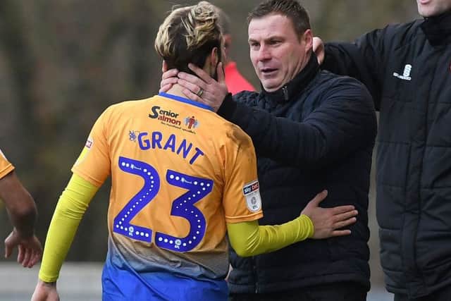 Mansfield's Jorge Grant celebrates his opening goal against Macclesfield with manager David Flitcroft.