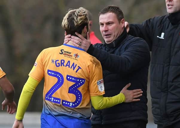 Mansfield's Jorge Grant celebrates his opening goal against Macclesfield with manager David Flitcroft.