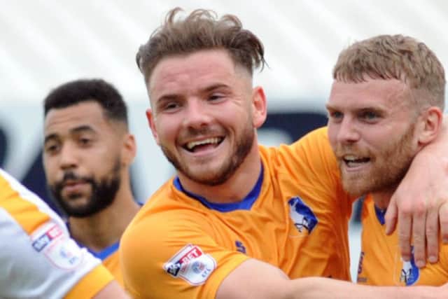 Alex MacDonald (centre) celebrates a Stags goal.
